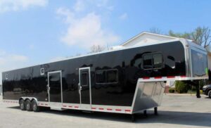 Black custom gooseneck trailers with multiple doors on each side.