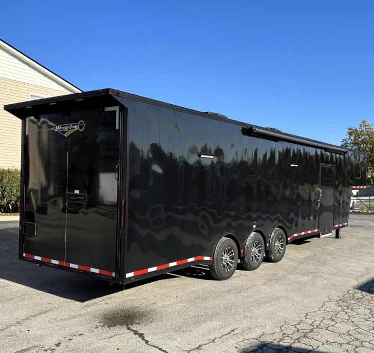 Enclosed Gooseneck Trailer 2023 40' Rear Exterior Curbside View. Electric Awning, Rear Ramp Door, Rear Wing, Aluminum Wheels, LED Lights.