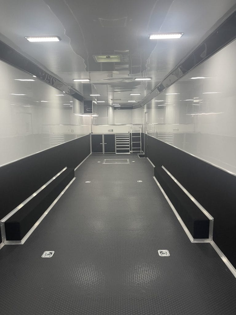 48' 2025 Interior Front View of a Haulmark Gooseneck Edge. This features black coin flooring, d-rings installed, aluminum walls with 36in. carpeted, c-tech toolbox & more!