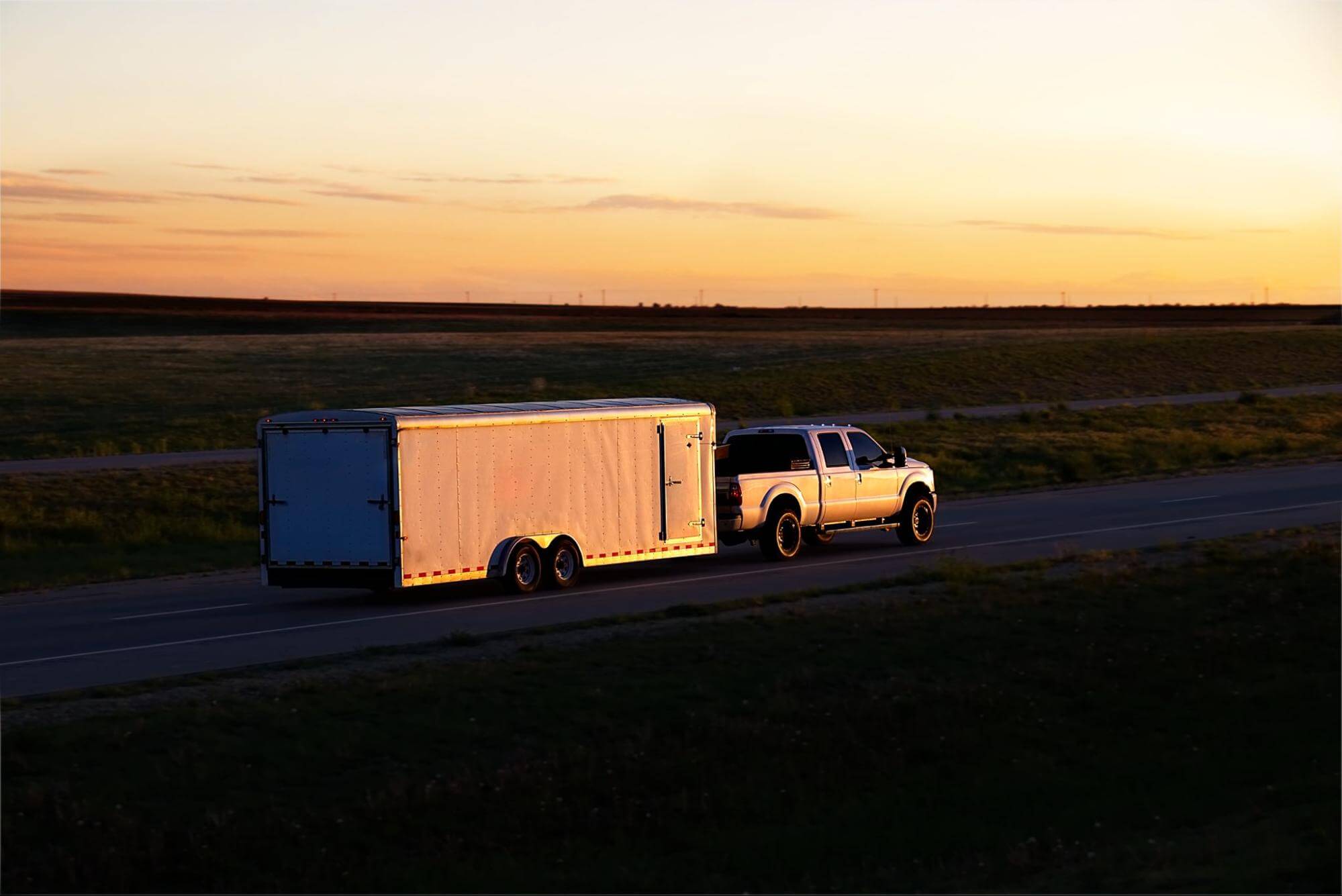 a pick-up truck with a cargo trailer