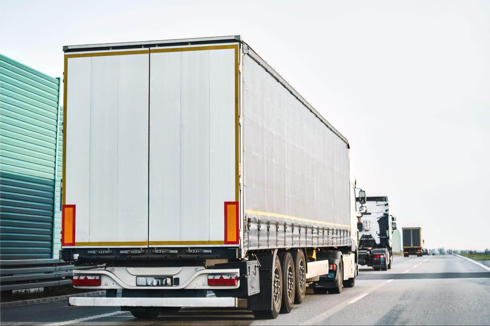 a truck with a trailer on the road