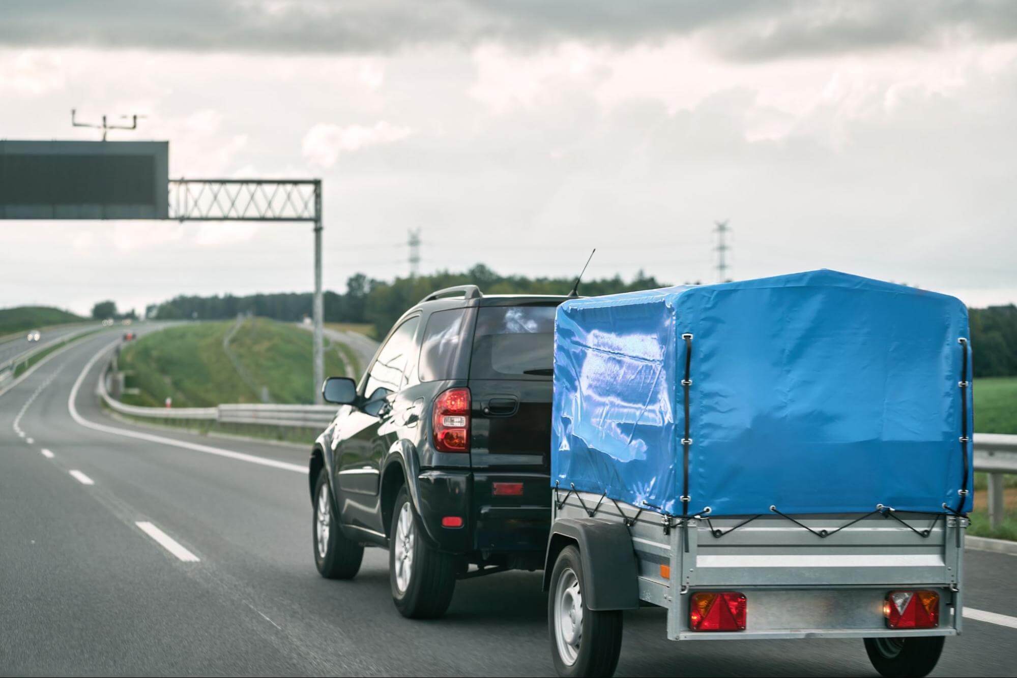 a car with a utility trailer