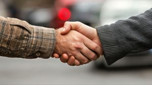 Two men shaking hands]