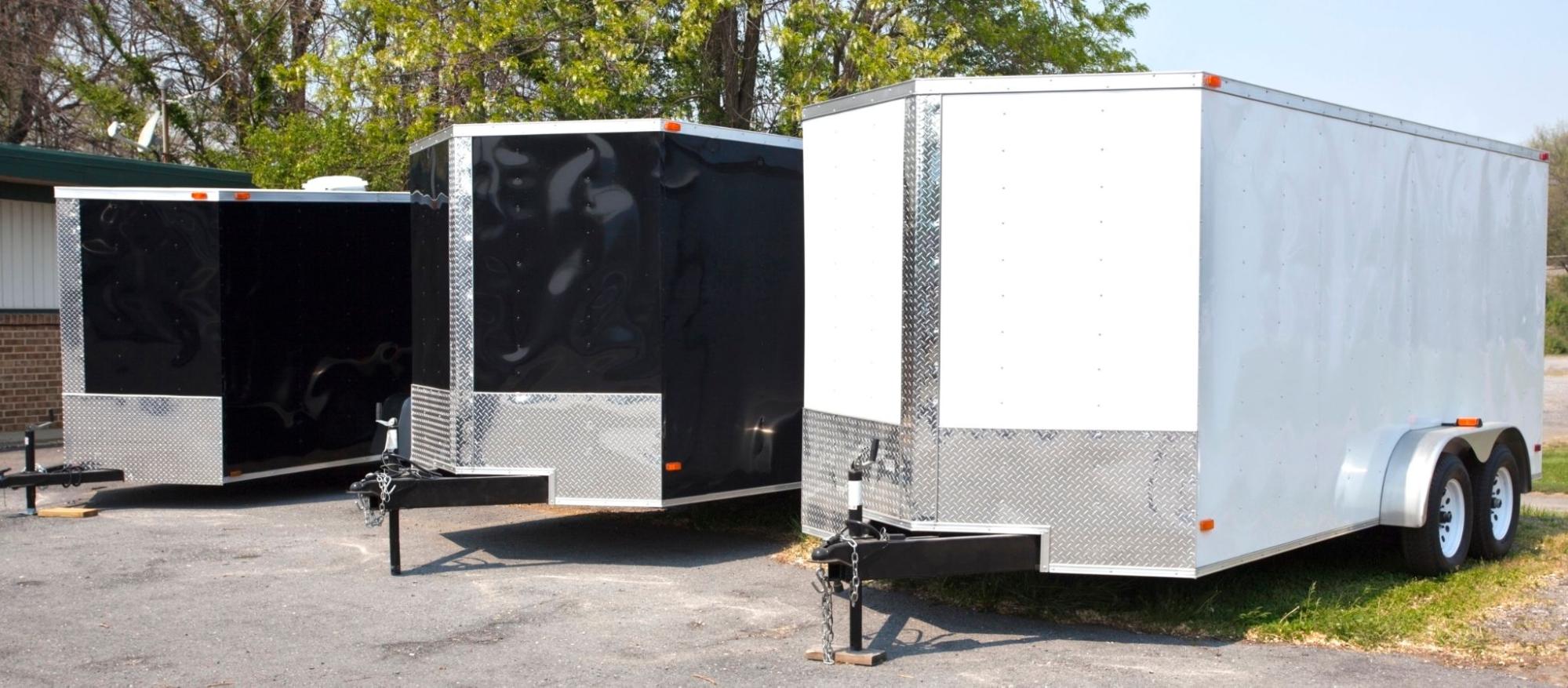 a row of enclosed trailers