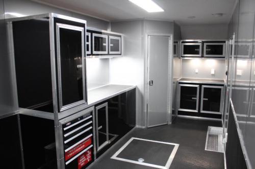 Interior custom cabinets for an enclosed trailers. Spare tire compartmnet in rubber coin floor and a bathroom